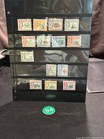 Full display of 17 North Borneo used stamps arranged in rows on black album page.