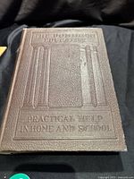 Front cover of the vintage book showing embossed title and decorative pillars.