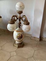 Full view of the vintage Italian porcelain 5-light lamp, showing the marble and brass base and five porcelain globe light fixtures.