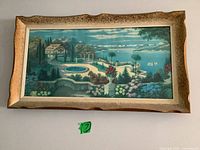 Full view of the framed art print showing the entire vibrant landscape scene including the villa, pool, garden, and ocean.