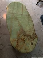 Top view showing the unique green marble table top with brown and cream veining pattern