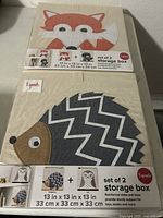 Top and front view of two 3 Sprouts fabric storage boxes in fox and hedgehog animal designs with product stickers and branding visible.