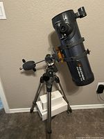 Celestron AstroMaster 114 optical tube mounted on equatorial mount with counterweight, aluminum tripod and finder scope attached