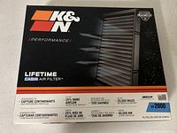 Box of K&N VF2000 cabin air filter showing branding and key features including washable, reusable, 25% more airflow, lifetime warranty.