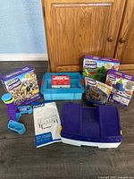Full set showing toys, sensory bin, and storage container arranged in front of wooden cabinet