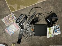 Full overview of Wii bundle contents including console, controllers, sensor bar, cables, games, VR headset, and DVD player.