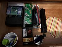 Top view showing Oxford ruled index cards, Scotch tapes, black stapler and a small round container with markers and glue stick.