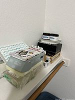 Complete view of Simply Earth DIY Soap Making Kit contents stacked including packaging box, guide book, molds, fragrance bottles, and coconut oil jars.