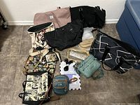 Wide view of 12 assorted bags of mixed style and colors arranged on floor