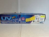 Box exterior showing Rainfresh Ultraviolet UV whole house water disinfection system branding, model H400, highlighting kills/inactivates bacteria, viruses.