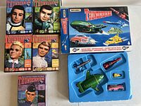 Matchbox Thunderbirds Rescue Pack box and blue plastic tray with diecast vehicles visible.