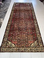Full view of the rectangular Persian rug showing overall condition and pattern.