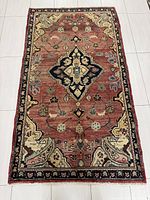 Full view of the Hamadan Persian rug showing its overall design and size on a tiled floor.