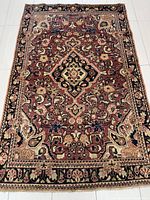 Full view of Arak handmade semi-antique Persian rug showing central medallion and overall pattern design.