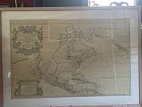Full view of the large framed map showing North and Central America with territorial boundaries and cartographic details.