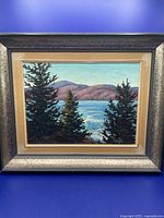 Frontal view of the original framed painting showing the landscape of Gatineau Hills with trees in foreground and water reflecting light.