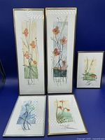 Group photo of 5 framed original watercolours showing mostly flowers and one sunset.