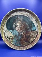 Photo of full front of tray showing woman in wide-brimmed hat and cigarette pack with pricing.