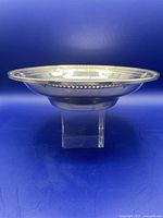 Side view of shallow bowl on clear stand