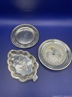 Overview of all three sterling silver dishes on blue background