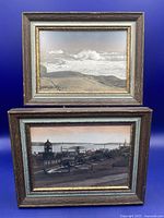 Two framed color prints by W R MacAskill displayed together, showing coastal and historic scenes.