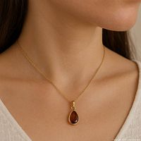 Pendant shown worn on model neck with chain