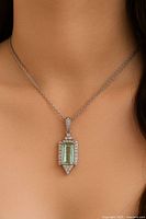 Pendant worn on model to show size and style