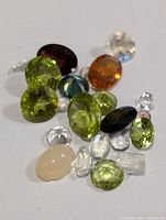 Photo showing assorted genuine gemstones in various colors and cuts.