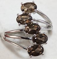 Close-up image showing the five oval smokey quartz stones set vertically on the silver split shank.