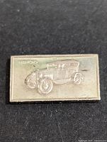 Front side of silver bar showing vintage Ford car embossment and weight 1.61g