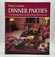 Front cover of the Betty Crocker's Dinner Parties cookbook showing a vintage living room party setup with food and decorations.
