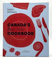 Front cover of the cookbook showing title, design, and branding, photographed on a white background.