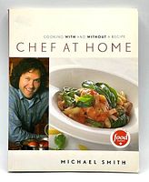 Front cover of the softcover cookbook showing Michael Smith and a plated shrimp dish with the Food Network logo.