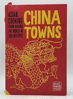 Front cover of the red hardcover cookbook with yellow title 'China Towns' and an illustrated gold dragon.