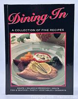 Front view of the cookbook showing the cover with the title, author, and a plated fish dish.