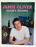 Front cover of the cookbook showing Jamie Oliver sitting in a kitchen setting, with clear title text.