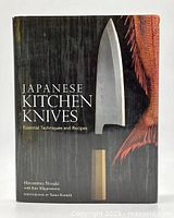 Front cover of the hardcover book 'Japanese Kitchen Knives: Essential Techniques and Recipes' showing a Japanese kitchen knife and fish image.