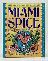 Front cover of the softcover cookbook titled Miami Spice: The New Florida Cuisine by Steven Raichlen featuring colorful illustration and text.