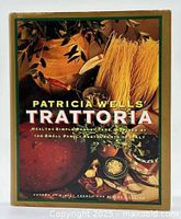 Front cover of Patricia Wells' Trattoria cookbook showing the title and food elements including pasta and herbs.