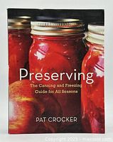 Front cover of the book 'Preserving' showing jam jars and apples, title and author clearly visible.