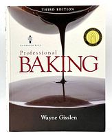 Front cover of the Professional Baking 3rd Edition hardcover book by Wayne Gisslen showing the title, author, and award seal.