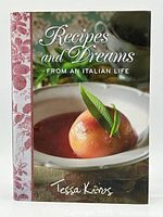 Front cover of the cookbook showing the title, author, and a plated dish with a poached fruit garnish.