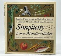 Front cover of the hardcover cookbook showing title, author, and food illustrations.