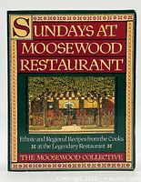 Front cover of the cookbook showing title and illustrated restaurant scene with decorative border