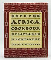 Front cover of The Africa Cookbook: Tastes of a Continent showing title and author's name with tribal design on hardcover.