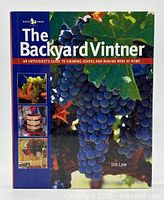 Front cover of The Backyard Vintner book showing blue grapes and smaller inset images related to wine making.