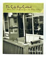 Front cover of The Cafe Pongo Cookbook featuring a black and white photo of the cafe entrance with outdoor seating on a green background.