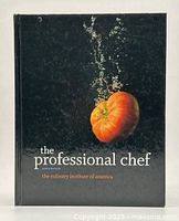 Front cover of The Professional Chef book by The Culinary Institute of America showing a tomato underwater against a black background.