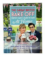 Front cover of The Great British Bake Off cookbook with hosts and baked goods shown