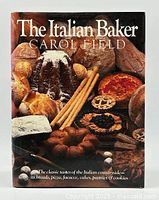 Front cover of 'The Italian Baker' showing an assortment of Italian breads and pastries.